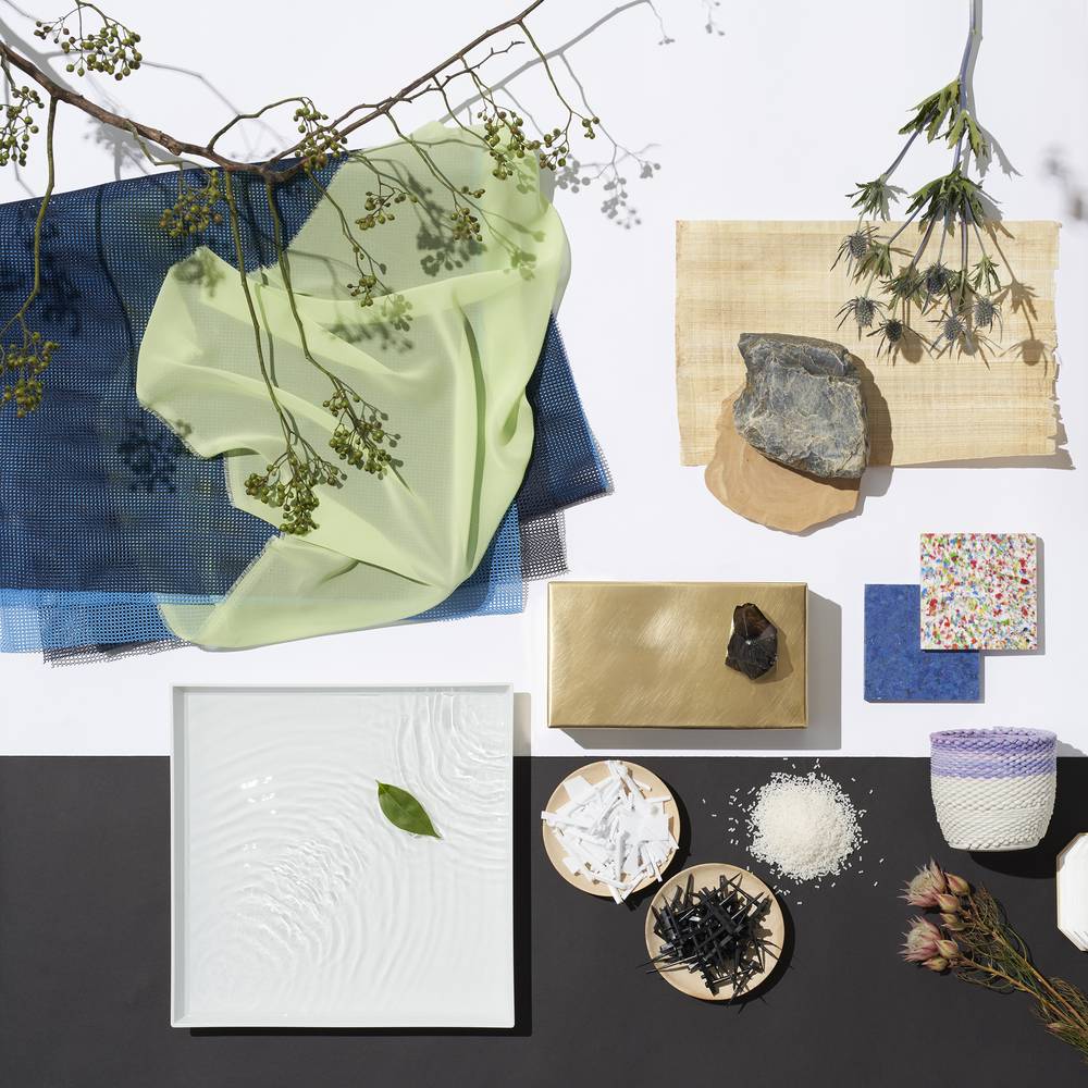 Flat lay of CMF design elements for 2025 trends featuring natural textures, translucent fabrics in pastel tones.