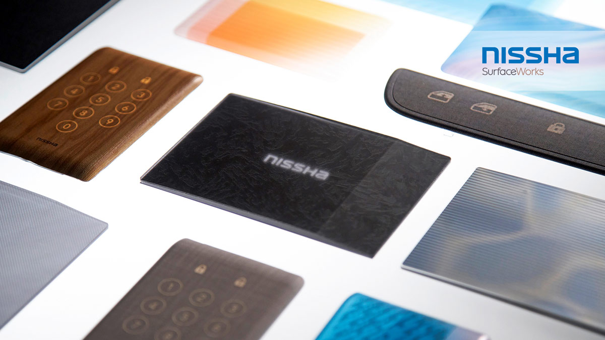 Nissha SurfaceWorks branded surface material and touch panel samples in various textures.