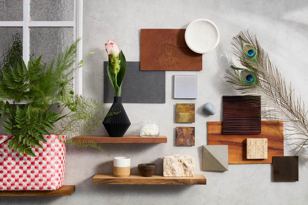 CMF design mood board with material samples, plants, and decorative objects.